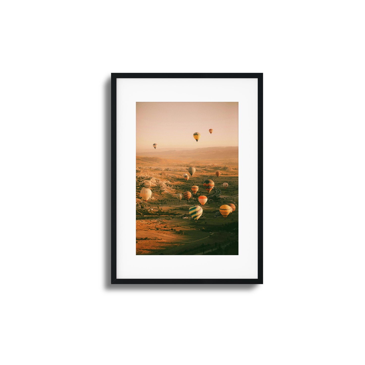 Colorful hot air balloons above a calm valley.