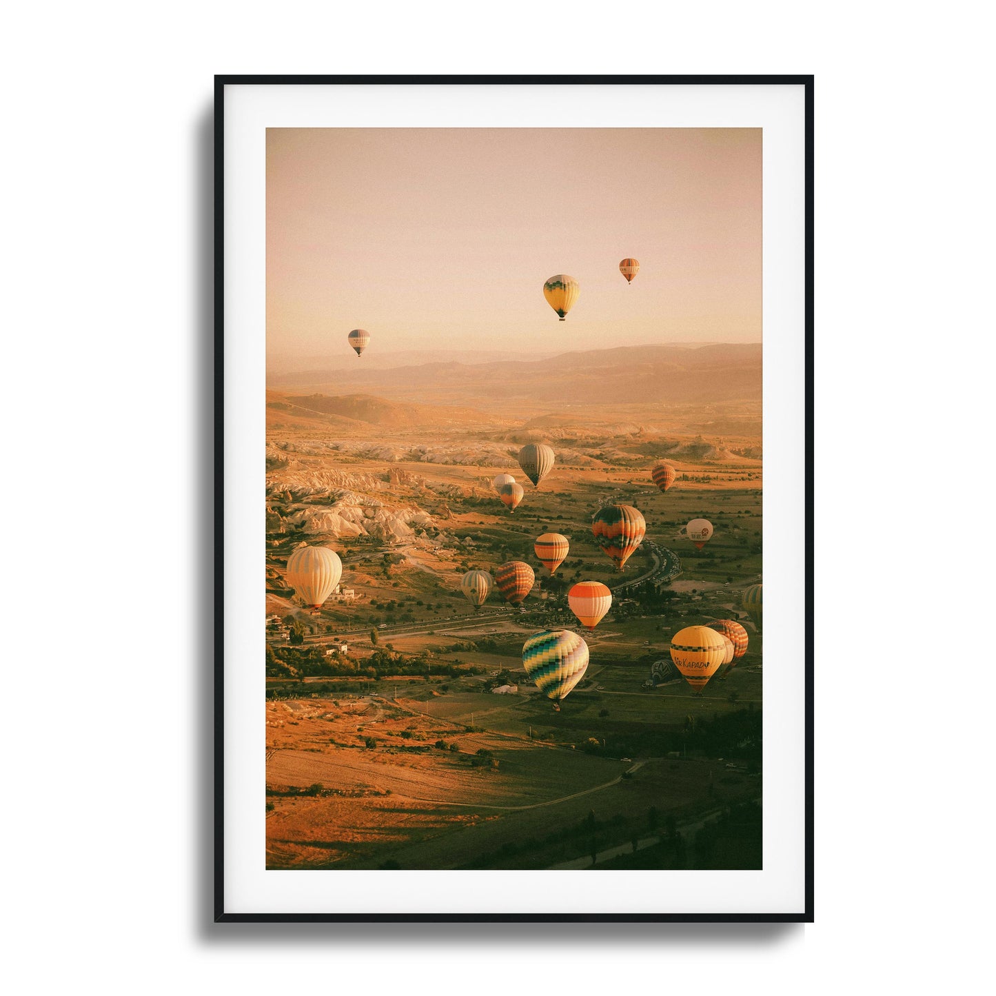 Colorful hot air balloons above a calm valley.