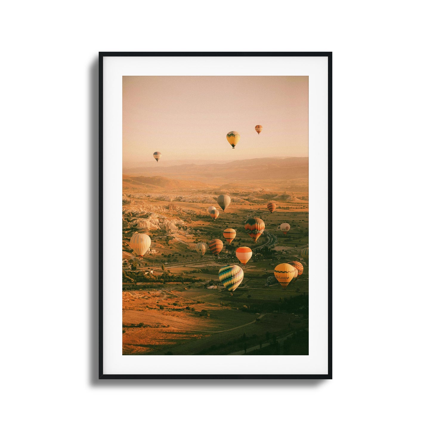 Colorful hot air balloons above a calm valley.