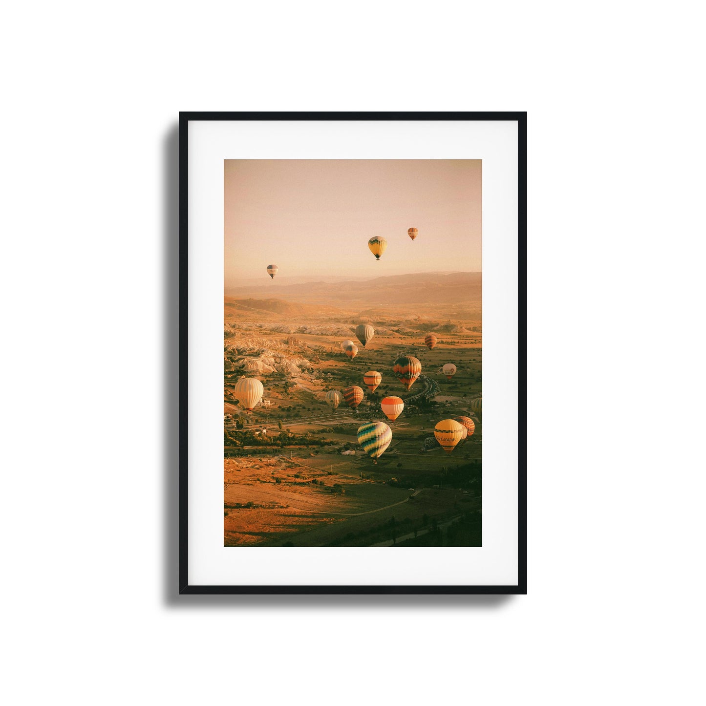 Colorful hot air balloons above a calm valley.