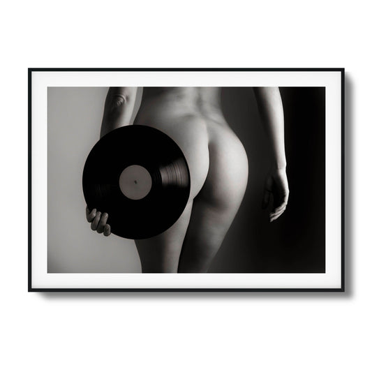 Black-and-white artistic photo of a vinyl record and figure