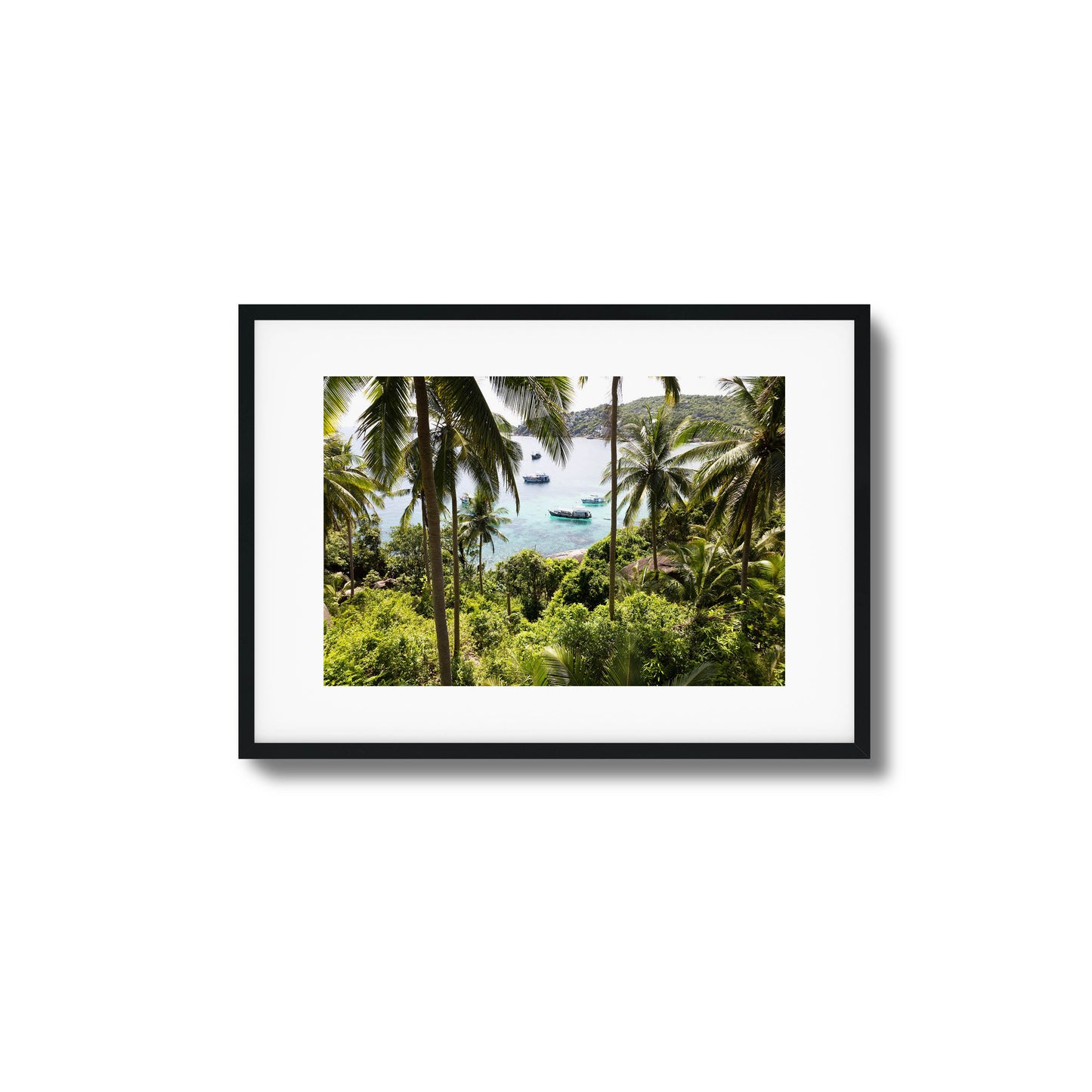 Tropical scene with palm trees and boats in clear water framed art