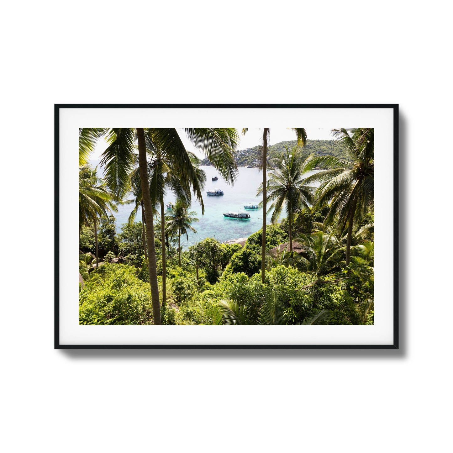 Tropical scene with palm trees and boats in clear water framed art