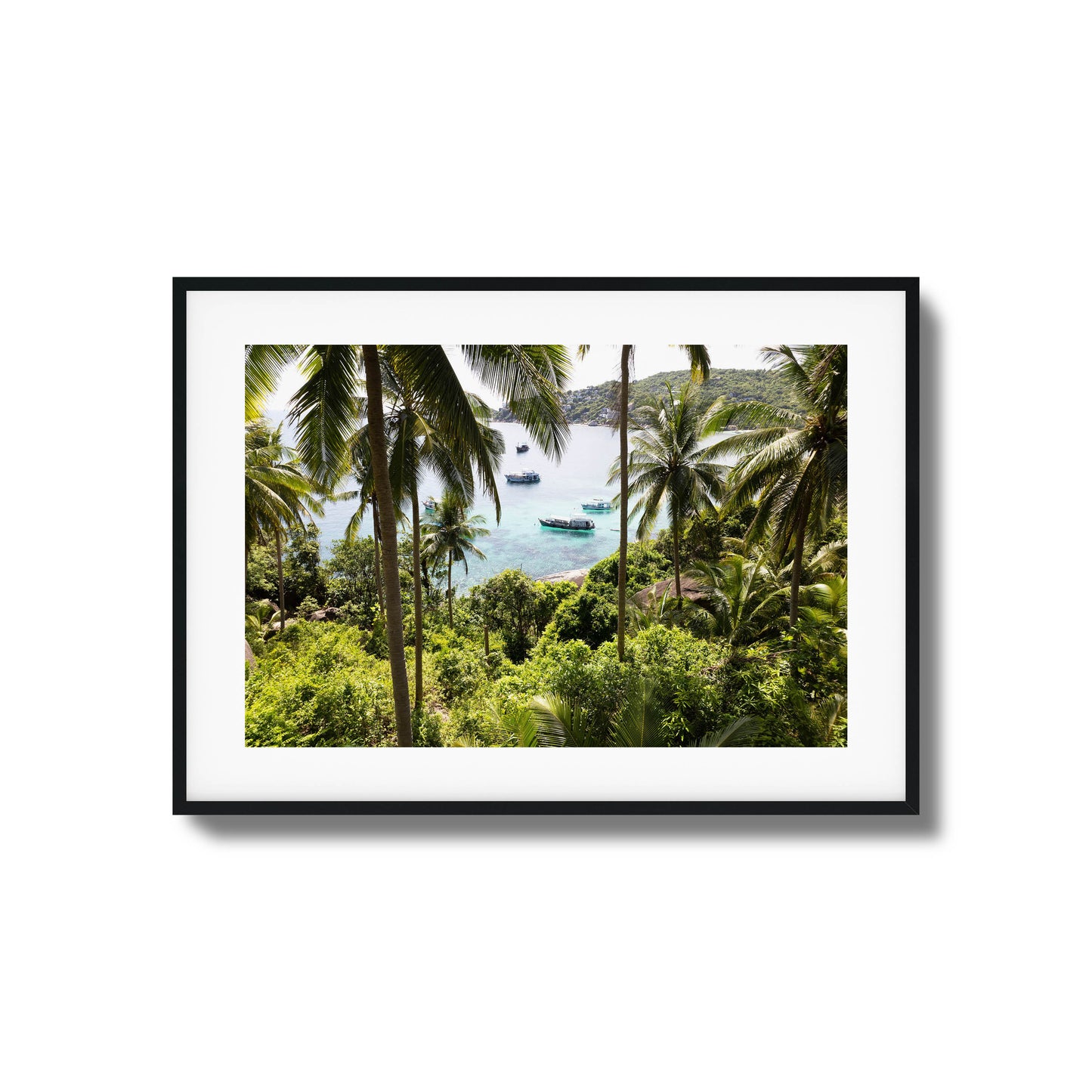 Tropical scene with palm trees and boats in clear water framed art