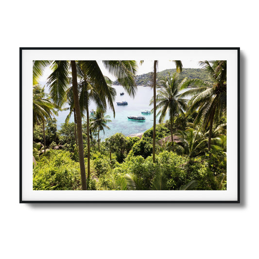 Tropical scene with palm trees and boats in clear water framed art