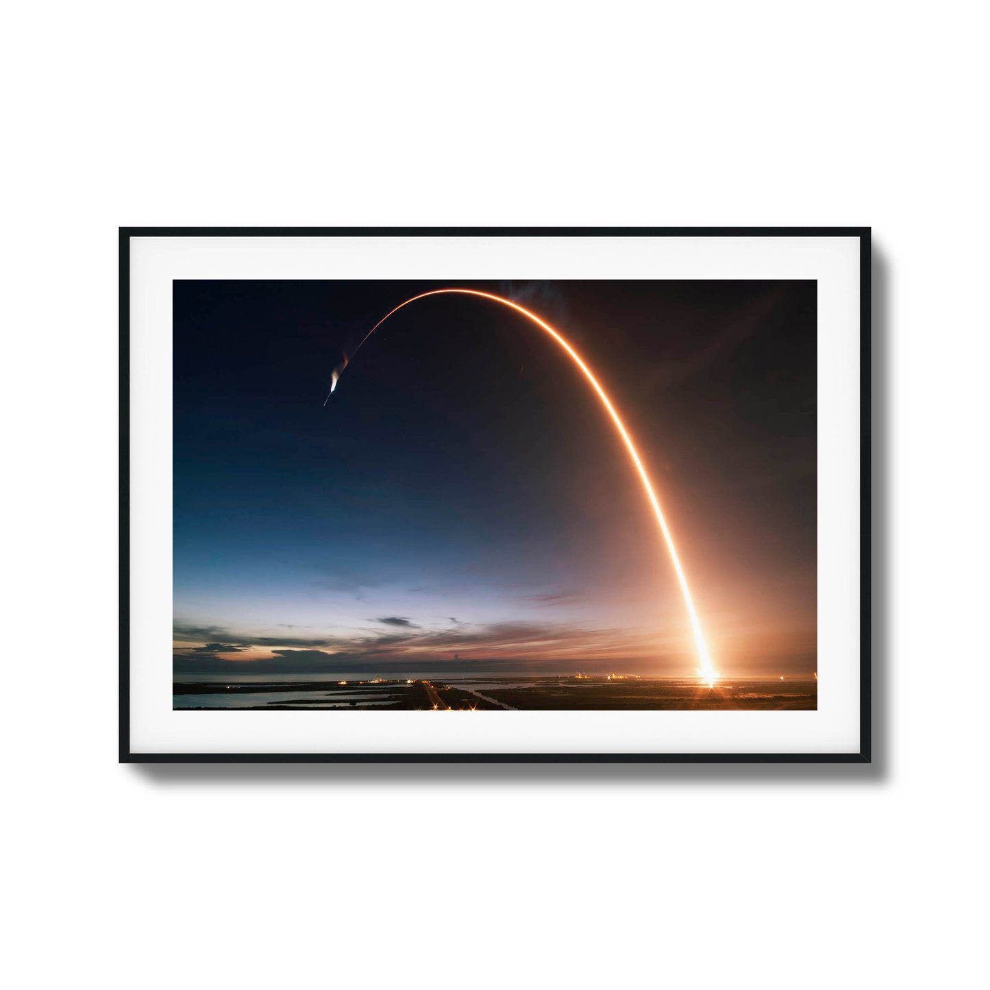 Long-exposure image of a rocket launch at twilight