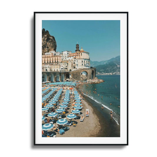 Colorful beach umbrellas by a serene coastal backdrop.