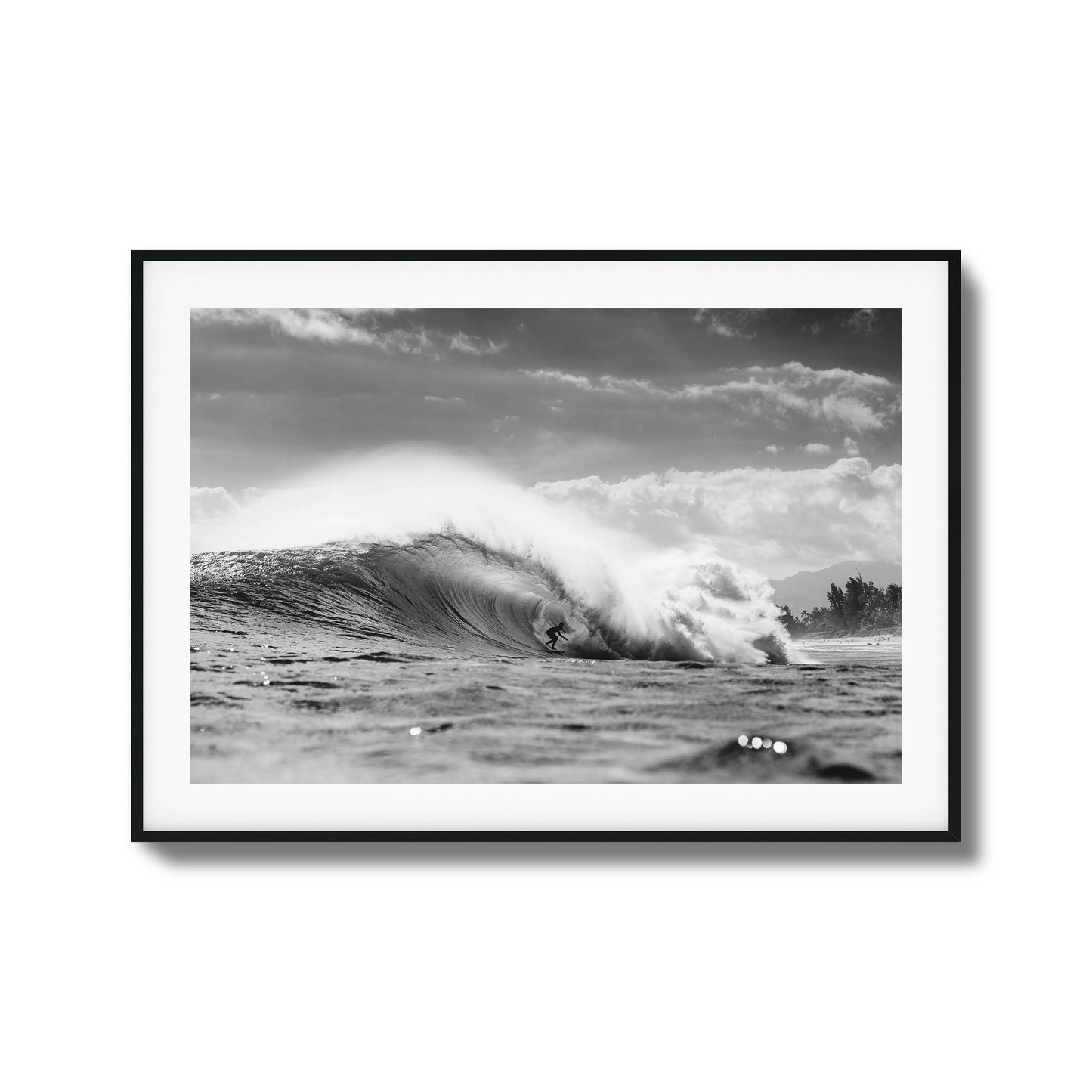 Surfer riding a large ocean wave in monochrome.