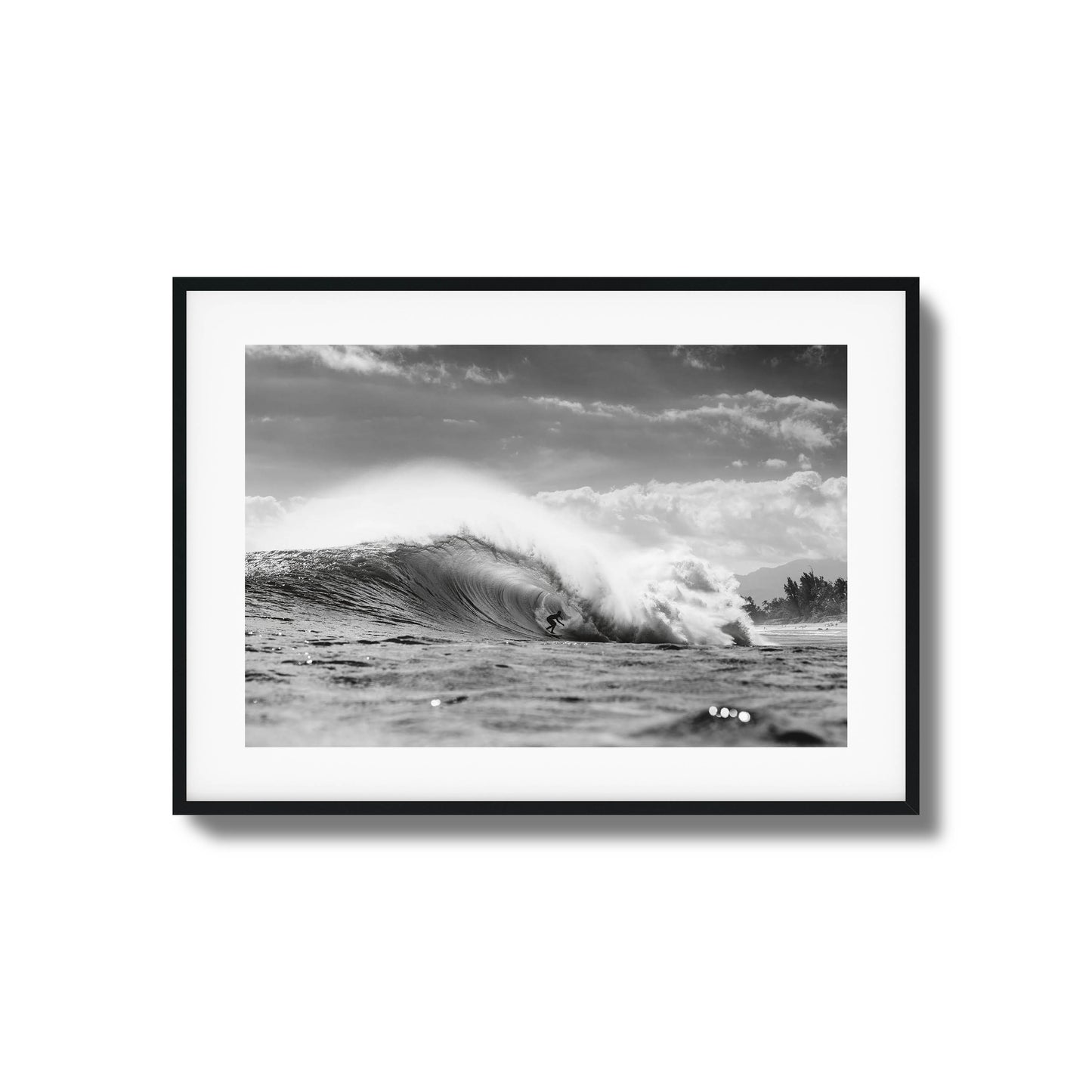 Surfer riding a large ocean wave in monochrome.