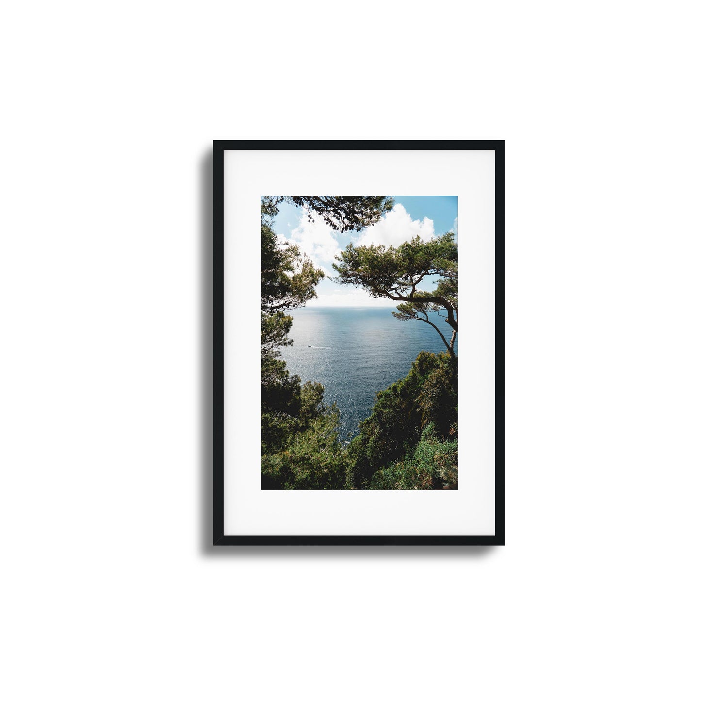 Ocean framed by lush greenery under a sunny sky, ideal for tranquil framed wall art.