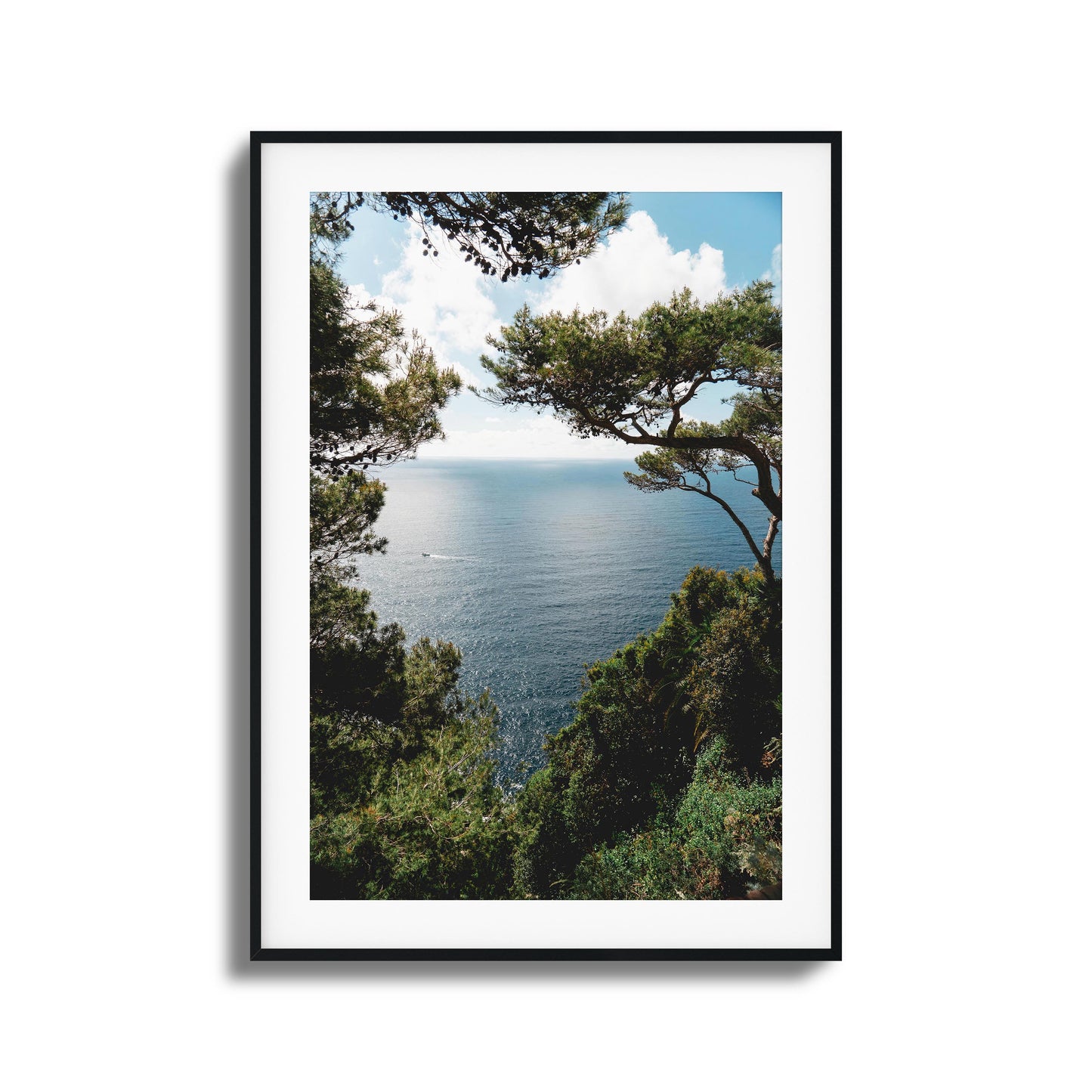 Ocean framed by lush greenery under a sunny sky, ideal for tranquil framed wall art.