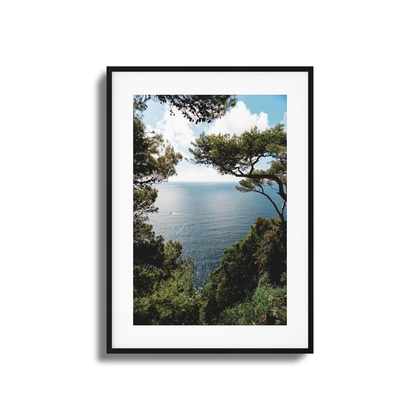 Ocean framed by lush greenery under a sunny sky, ideal for tranquil framed wall art.